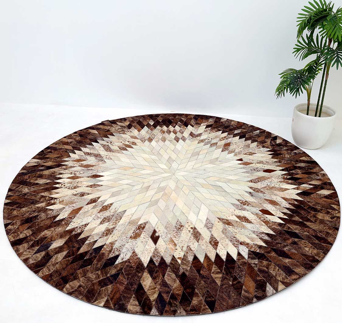 The RAMSHA HOME Multi Color Guest Room Round Decor Leather Rug - LR 022, featuring a geometric starburst pattern in brown, cream, and beige, is placed on a white floor beside a potted green plant against a plain white wall.