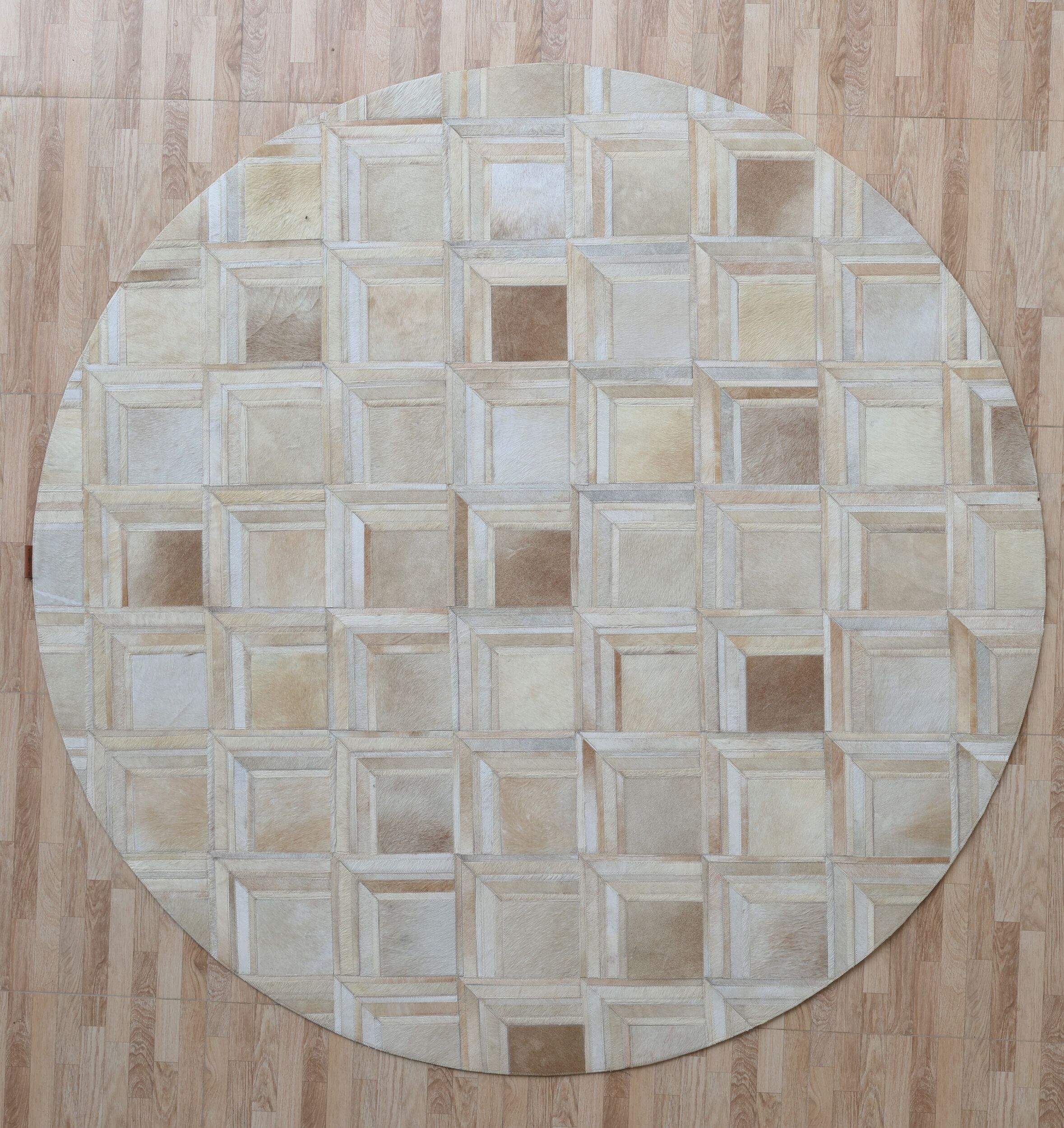 The RAMSHA HOME Multi Color Round Leather Rug - LR 023 features a 3D cube pattern in beige and light brown, complementing wooden floors with matching tones.