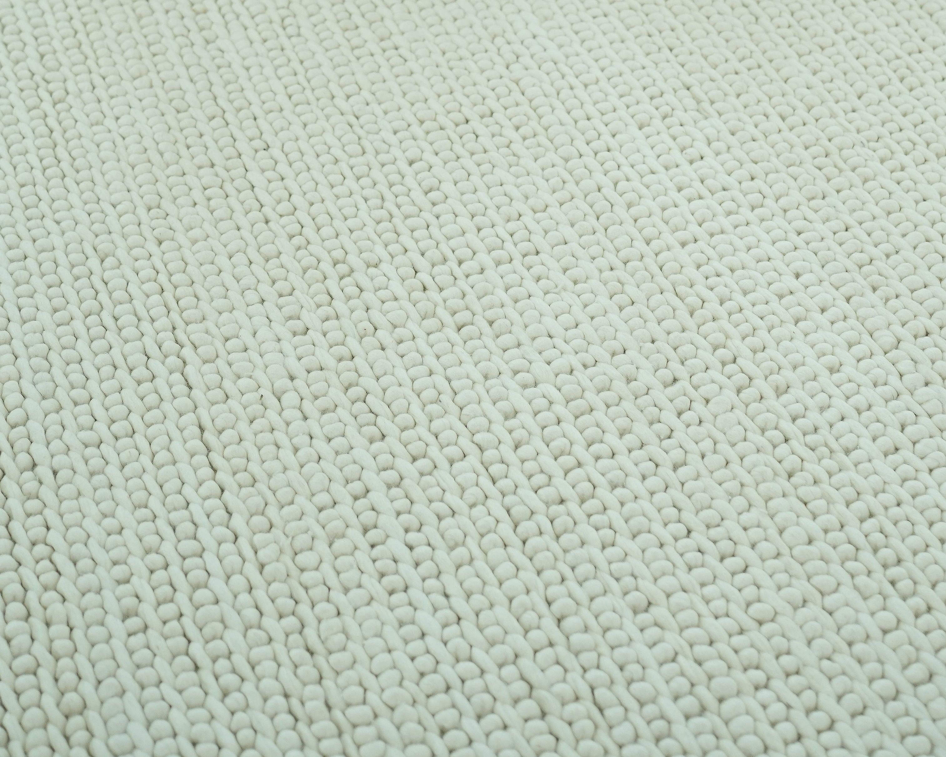 Close-up of the Handmade Natural White Woven Rug For Home Decor SRN-031, featuring an ivory woven pattern with small, rounded loops made from premium New Zealand wool.