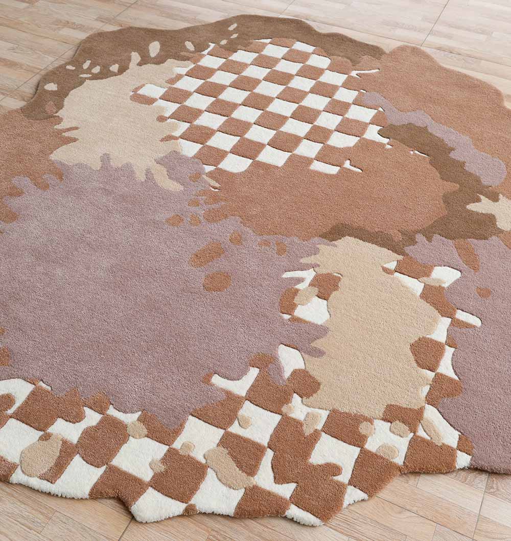 The RAMSHA HOME Handmade Multicolor Area Bespoke Rug HTW 128 (200cm) with a distorted checkerboard and abstract beige, brown, and cream splashes is placed on a light wood floor.