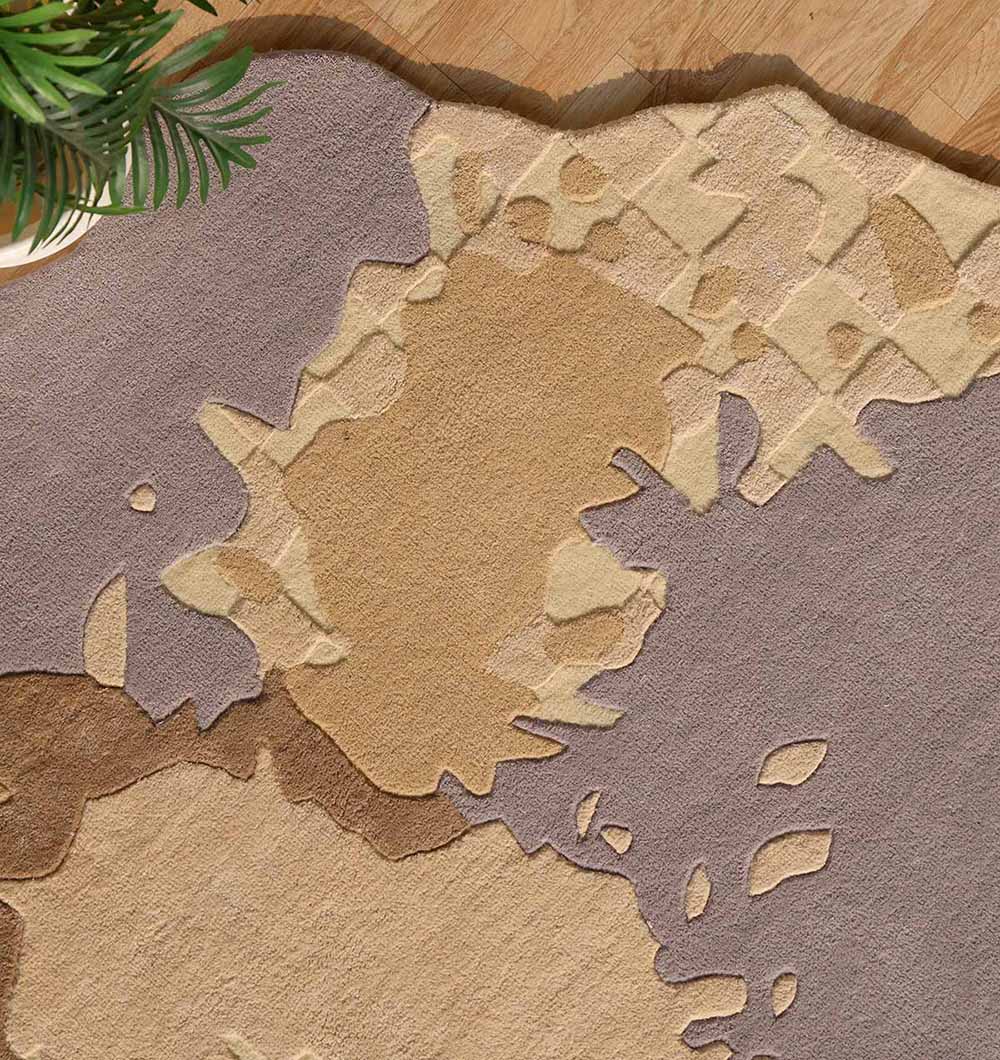 The RAMSHA HOME Abstract Shaped Handmade Area Rug-HTWV 174 (200x300 cm), featuring beige, tan, and light brown tones in a modern design, lies on a wooden floor with a green plant in the corner.