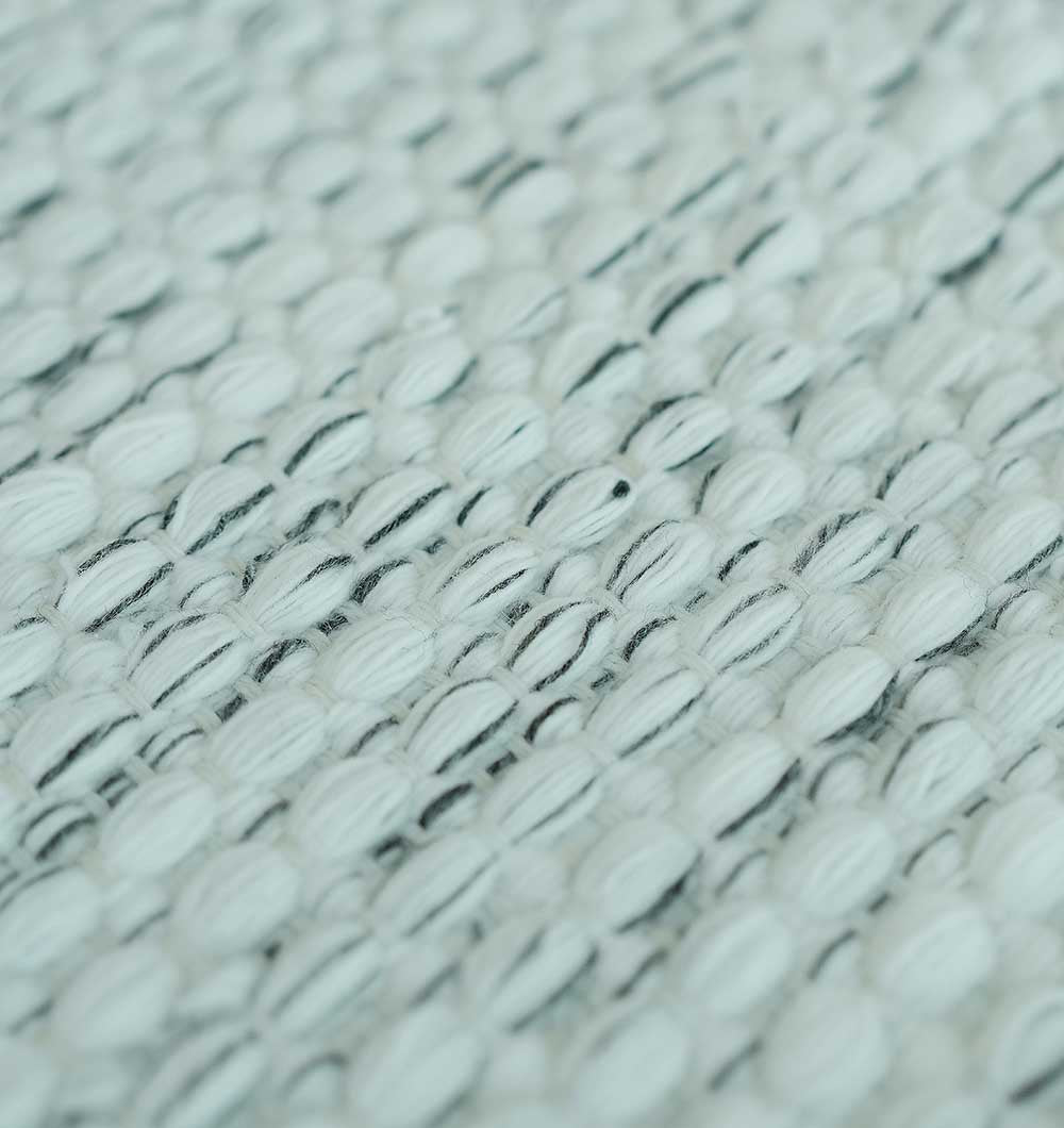 Close-up of the Durable Handmade Natural White Woven Area Rug SR-058 by RAMSHA HOME, featuring a textured ivory surface with thick, raised threads forming a grid pattern and subtle color variation for added depth.