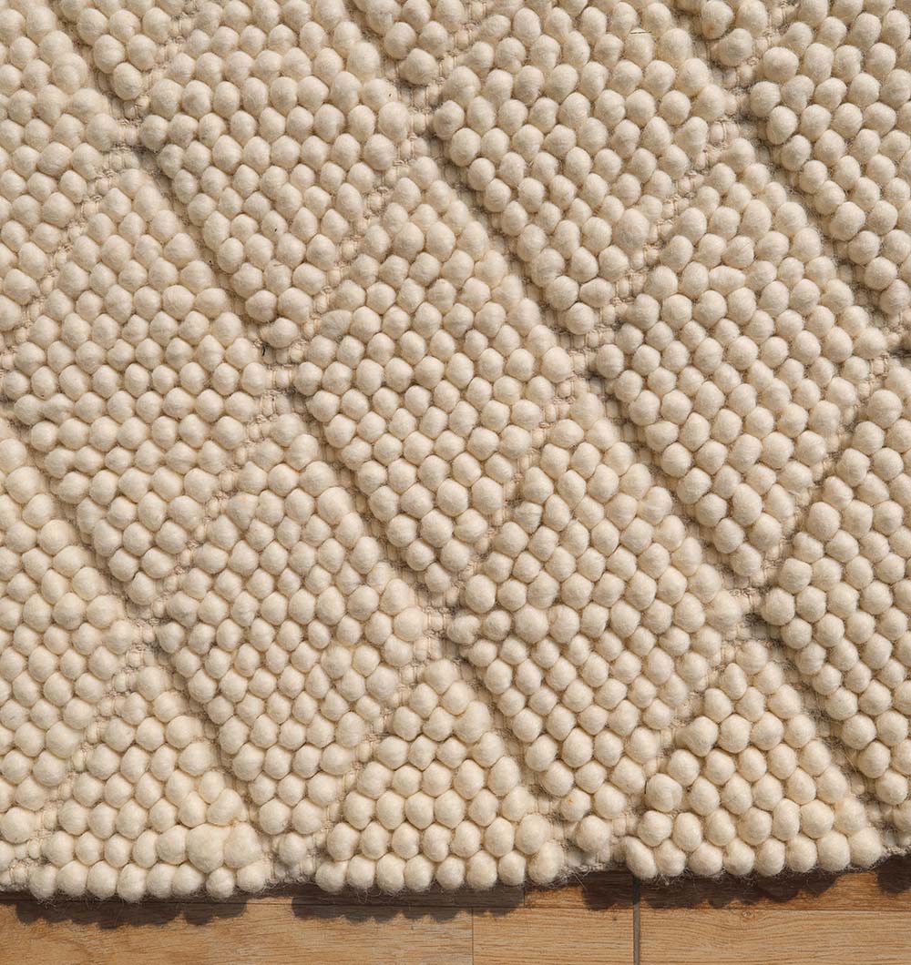 Detailed shot emphasizing the resilience and natural stain resistance of the premium wool and cotton blend fibers.