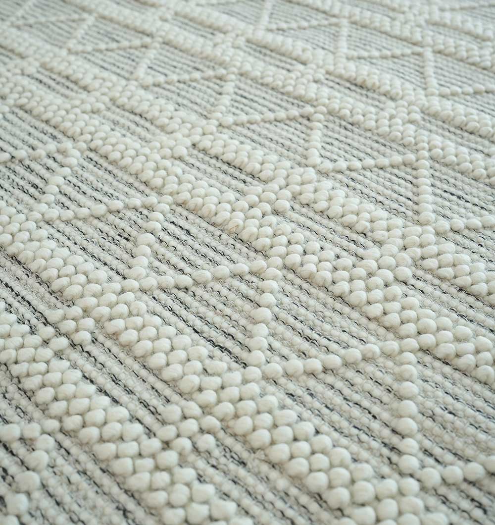 Close-up of RAMSHA HOME Wool Woven Rug Area Rug with Natural Color SRN-040, featuring textured weave and raised white tufted dots in geometric patterns—ideal for adding subtle style to your living room decor.