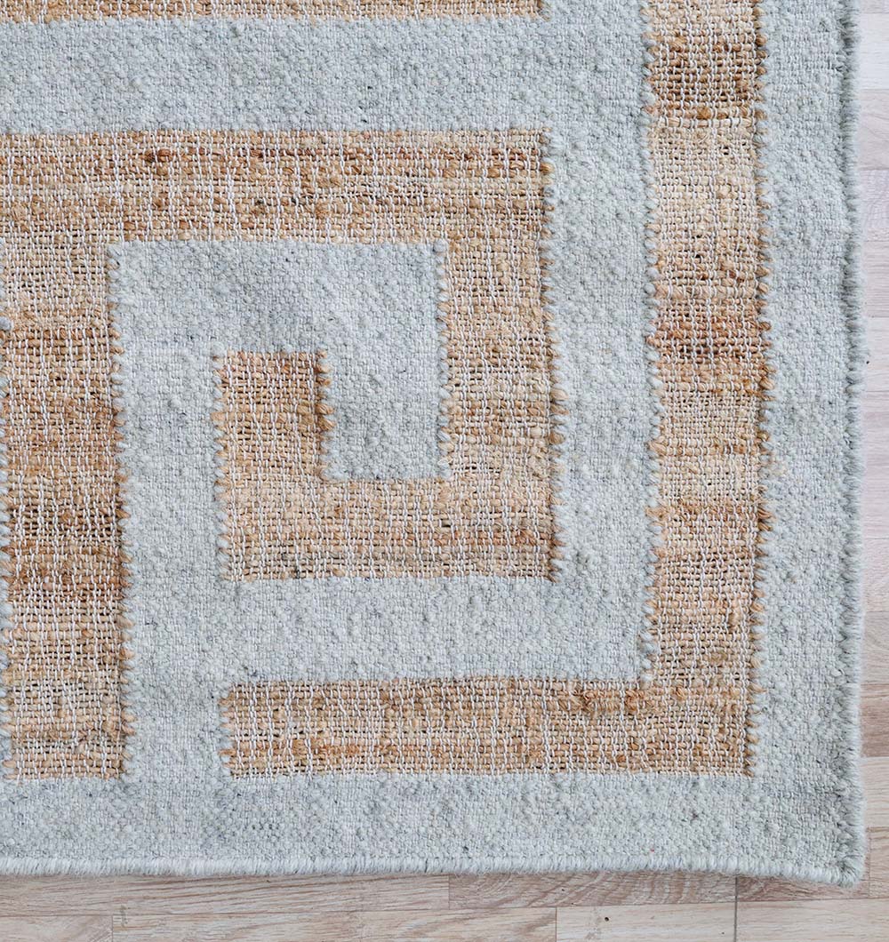 The Decorative Woven Rug For Living Room WR-038 by RAMSHA HOME features a light gray background with a tan Greek key pattern, displayed on a light wood floor.