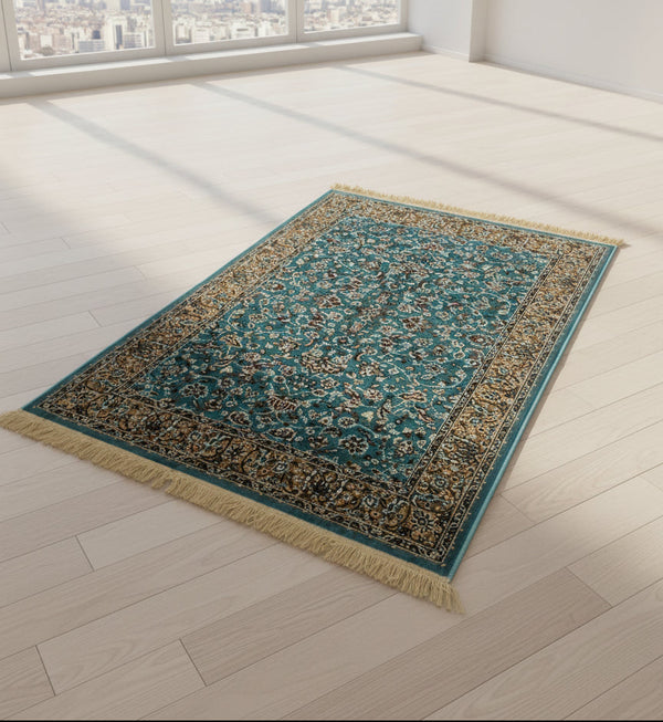 Teal patterned rug on a light wooden floor with large windows showing a cityscape.